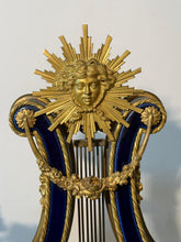 Load image into Gallery viewer, A French Three Piece Porcelain Lyre Clock Set.