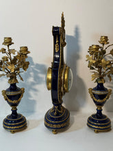 Load image into Gallery viewer, A French Three Piece Porcelain Lyre Clock Set.