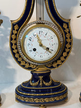 Load image into Gallery viewer, A French Three Piece Porcelain Lyre Clock Set.