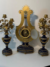 Load image into Gallery viewer, A French Three Piece Porcelain Lyre Clock Set.