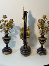 Load image into Gallery viewer, A French Three Piece Porcelain Lyre Clock Set.